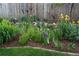 Backyard flower bed with colorful irises and lush greenery, adding natural beauty and curb appeal at 7189 S Kline St, Littleton, CO 80127