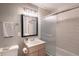 Well-lit bathroom features tile flooring, a vanity with storage, a shower with glass doors, and a modern mirror at 7189 S Kline St, Littleton, CO 80127