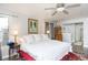 Bright bedroom featuring hardwood floors, large bed, a ceiling fan, and neutral-colored walls at 7189 S Kline St, Littleton, CO 80127
