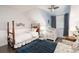 Well-lit bedroom with a window, ceiling fan, crib and wood-frame bed and hardwood floors at 7189 S Kline St, Littleton, CO 80127