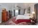 Inviting bedroom with a ceiling fan, large rug, and sliding glass doors leading to an outdoor space at 7189 S Kline St, Littleton, CO 80127