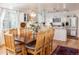 Dining room with views into kitchen and seating for eight at 7189 S Kline St, Littleton, CO 80127