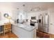 Bright kitchen featuring white cabinets, granite countertops, stainless steel appliances, and hardwood floors at 7189 S Kline St, Littleton, CO 80127