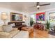 Inviting living room featuring hardwood floors, a leather sofa, and unique decor, perfect for relaxation and entertaining at 7189 S Kline St, Littleton, CO 80127