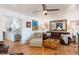 Open living room with hardwood floors, a view of the modern kitchen, and comfortable seating, providing an inviting atmosphere at 7189 S Kline St, Littleton, CO 80127