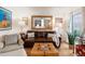 Comfortable living room with hardwood floors, a leather sofa, and a large mirror, creating a cozy and stylish space at 7189 S Kline St, Littleton, CO 80127