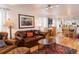 Inviting living room featuring a leather sofa and chairs, hardwood floors, and access to the dining area at 7189 S Kline St, Littleton, CO 80127