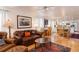 Open living space with hardwood floors, leather seating, and view into dining and kitchen at 7189 S Kline St, Littleton, CO 80127