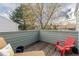Outdoor patio area with wood flooring, adirondack chair, and view of the surrounding neighborhood at 7189 S Kline St, Littleton, CO 80127