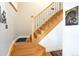 Bright wood staircase with iron railing leading to the upper level of the home at 7189 S Kline St, Littleton, CO 80127