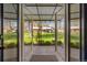 View from inside the house, through glass doors, to a large, green backyard at 6314 Brooks Dr, Arvada, CO 80004