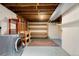 Unfinished basement laundry area with a washer, storage shelves, and concrete floor at 6314 Brooks Dr, Arvada, CO 80004
