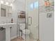 Bathroom features a pedestal sink, tiled shower with glass door and decorative tile border at 6314 Brooks Dr, Arvada, CO 80004