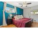 Cozy bedroom with bright accent wall, hardwood floors and natural light at 6314 Brooks Dr, Arvada, CO 80004