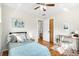 Inviting bedroom with hardwood floors, a ceiling fan, with desk and bed with plush bedding at 6314 Brooks Dr, Arvada, CO 80004