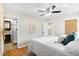 Bedroom featuring hardwood floors and an ensuite bathroom with glass shower at 6314 Brooks Dr, Arvada, CO 80004