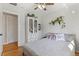 Cozy bedroom featuring hardwood floors, white walls, and comfortable bedding at 6314 Brooks Dr, Arvada, CO 80004