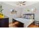 Relaxing bedroom with hardwood floors, a ceiling fan, and two windows at 6314 Brooks Dr, Arvada, CO 80004