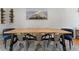 Dining room with a light wood table, metal chairs, and an eye-catching mountain artwork at 6314 Brooks Dr, Arvada, CO 80004