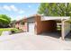 Charming brick home featuring a convenient carport, garage, and a well-manicured lawn, perfect for suburban living at 6314 Brooks Dr, Arvada, CO 80004