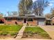 Charming brick ranch-style home with well-maintained lawn and solar panels at 6314 Brooks Dr, Arvada, CO 80004