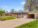 Charming brick home featuring solar panels, a one car garage and a car port at 6314 Brooks Dr, Arvada, CO 80004