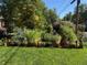 Lush garden featuring a variety of herbs and plants in raised wooden planters at 6314 Brooks Dr, Arvada, CO 80004