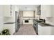Kitchen with stainless appliances, modern cabinets, and gray countertops at 6314 Brooks Dr, Arvada, CO 80004