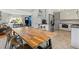 Open-concept kitchen/living area with modern appliances and hardwood table at 6314 Brooks Dr, Arvada, CO 80004