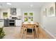 Eat-in kitchen features stainless appliances, tile backsplash, and a door to the outside at 6314 Brooks Dr, Arvada, CO 80004