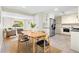 Eat-in kitchen with stainless appliances, tile backsplash, and an open floorplan at 6314 Brooks Dr, Arvada, CO 80004