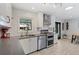 Updated kitchen featuring modern backsplash and stainless steel appliances at 6314 Brooks Dr, Arvada, CO 80004