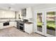 Well-lit kitchen with stainless steel appliances, herringbone floor and a view to the backyard at 6314 Brooks Dr, Arvada, CO 80004