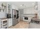 Bright kitchen with stainless steel appliances and herringbone wood-style floors at 6314 Brooks Dr, Arvada, CO 80004