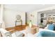Inviting living room featuring hardwood floors, neutral decor, and seamless flow into the kitchen at 6314 Brooks Dr, Arvada, CO 80004