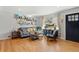 Bright living room with hardwood floors, fresh paint, and open shelves at 6314 Brooks Dr, Arvada, CO 80004