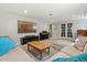 Comfortable living room with carpeting, neutral seating, a large television and a piano at 6314 Brooks Dr, Arvada, CO 80004