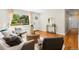Bright living room features hardwood floors, a large window, and neutral decor at 6314 Brooks Dr, Arvada, CO 80004