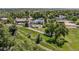Estate aerial view showcasing lush landscaping, white fencing, and private pool area at 13962 W 76Th Ln, Arvada, CO 80005