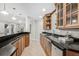 Bar area offers wood cabinetry, granite countertops, and convenient under-counter refrigerator at 13962 W 76Th Ln, Arvada, CO 80005
