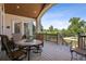 Covered deck with outdoor seating and scenic views of the backyard and pool at 13962 W 76Th Ln, Arvada, CO 80005