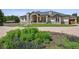 Charming home with manicured lawn and inviting entrance, featuring stone accents and a spacious driveway at 13962 W 76Th Ln, Arvada, CO 80005