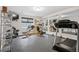 Home gym features weight training equipment, mirrors, and a treadmill at 13962 W 76Th Ln, Arvada, CO 80005