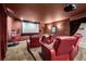 Home theater with plush seating, projection screen, and popcorn machine at 13962 W 76Th Ln, Arvada, CO 80005