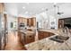 Spacious kitchen boasts dual islands, stainless steel appliances, and granite countertops at 13962 W 76Th Ln, Arvada, CO 80005