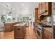 Spacious kitchen with granite countertops, stainless steel appliances, and custom cabinets, flowing into the living space at 13962 W 76Th Ln, Arvada, CO 80005