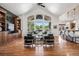 Bright living room with vaulted ceilings, large windows, hardwood floors, and stylish furnishings at 13962 W 76Th Ln, Arvada, CO 80005