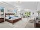 Airy bedroom with pillars, tray ceiling, and natural light from large windows at 13962 W 76Th Ln, Arvada, CO 80005