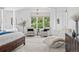 Sitting area inside main bedroom with natural light from large windows at 13962 W 76Th Ln, Arvada, CO 80005