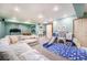 Spacious finished basement with a large sectional sofa and a play area for children at 10873 W 84Th Pl, Arvada, CO 80005